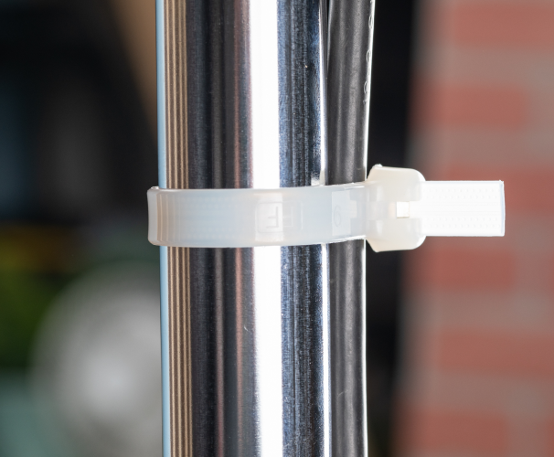 Once the cable tie is tightened around the cables or items being secured, the stainless pawl locks into place to prevent the tie from coming loose. This type of locking mechanism is commonly used in demanding environments or applications where added strength and durability are required.